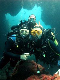 Two divers watch the smaller fish in the Marine Reserve in Gran Canaria