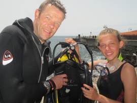 Father and Daughter divers compare their guages to check their equipment.